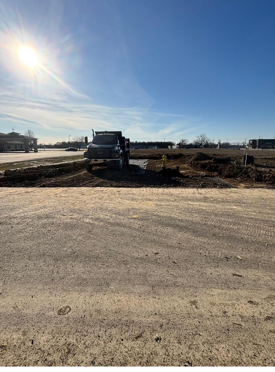 Dump truck delivering stone on an active site