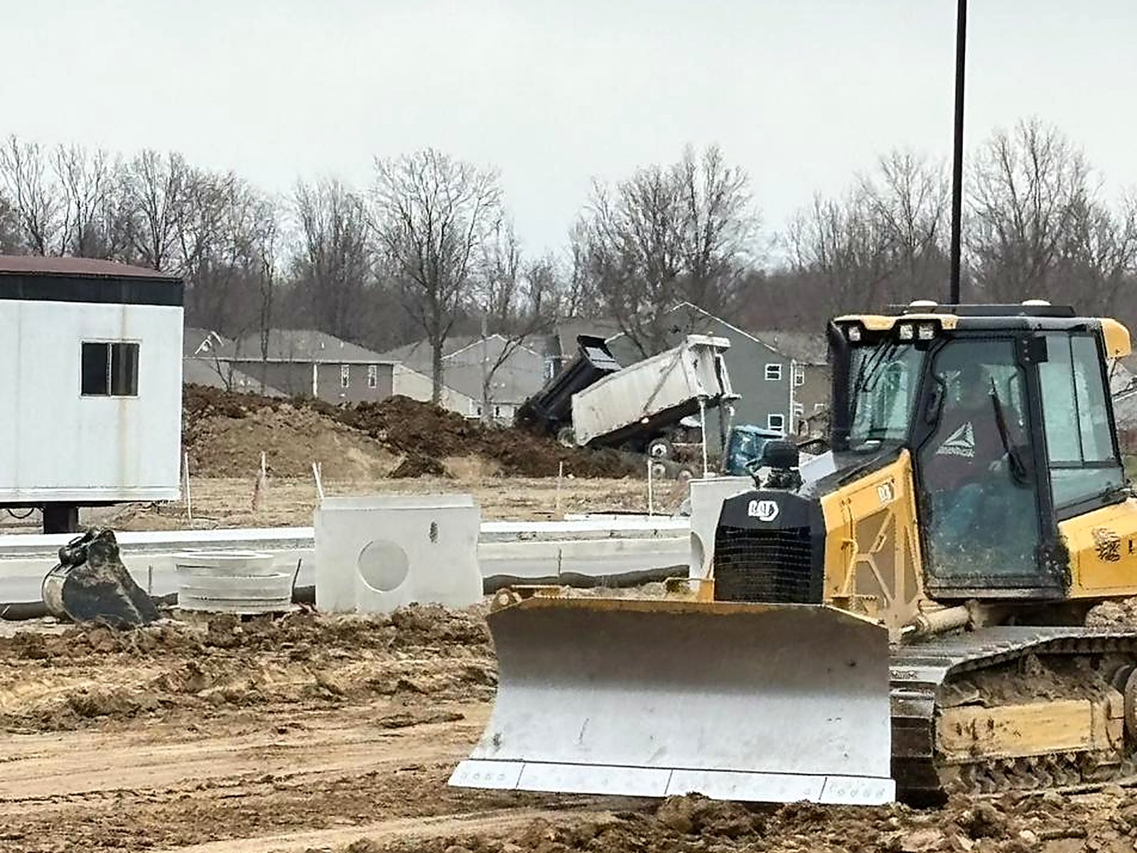 Dozer with GPS blade grading a commercial building site