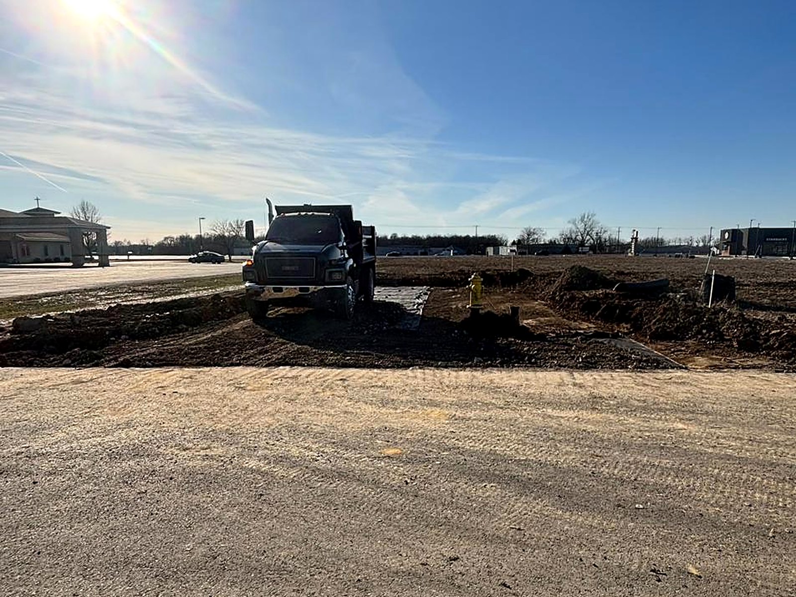Dump truck delivering stone on site